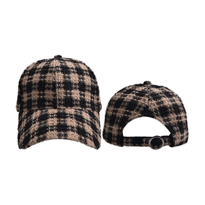 Detail of tweed baseball cap with houndstooth pattern and metal back buckle