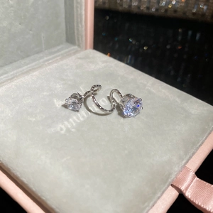 Detailed view of silver zircon water drop earrings in a luxury jewelry display box