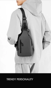 Detailed view of gray waterproof sling bag with USB charging port and adjustable strap
