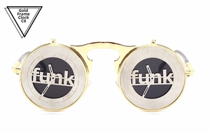 Detail of steampunk flip-up sunglasses with gold metal frame and funk clock design