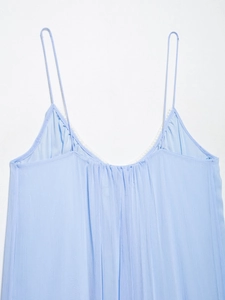 Detail of light blue camisole dress with white lace V-neckline and pleated texture
