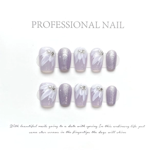 Detail of lavender press-on nails with hand-painted flowers, pearls and glitter texture