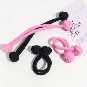 Close-up of pink and black braided knot hair ties with high elastic fiber texture