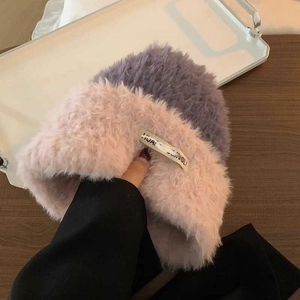 Close-up of thick pink and grey plush knit hat with soft faux fur texture for winter