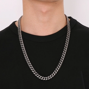 Classic silver-tone stainless steel Cuban chain necklace on male model with black t-shirt