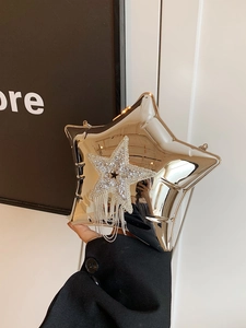 Detail of silver star-shaped clutch with rhinestone embellishments and metallic tassels