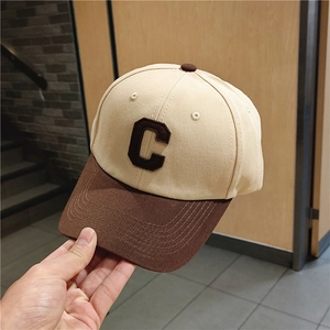 Structured beige baseball cap with brown brim and large C letter embroidery detail
