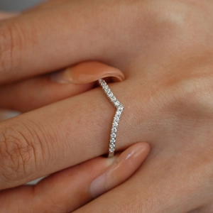 Detailed close-up of a shimmering V-shaped crown ring with micro-pave cubic zirconia