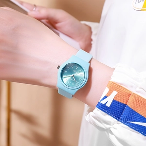 Close-up of a light blue silicone quartz watch with white Arabic numerals on the wrist