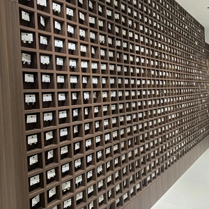 A wide variety of elegant pearl earrings displayed on a professional wooden grid wall