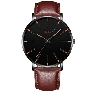 Detail of classic quartz watch with brown leather strap and orange markers on black dial
