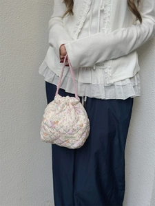 Detail of floral quilted drawstring bag with pink handles and Sozakku brand label