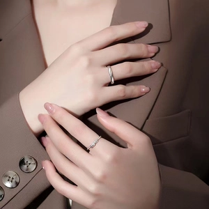 Cupid feather matching couple rings in silver finish worn by a model on hands