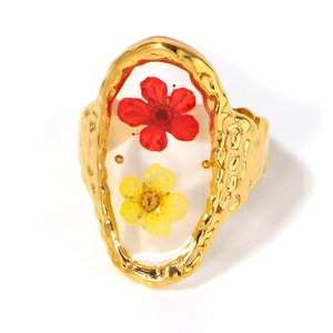 Golden irregular frame ring with red and yellow dried flowers in clear resin