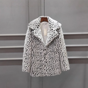 Chic mid-length faux fur coat with bold black spots on white base for winter fashion