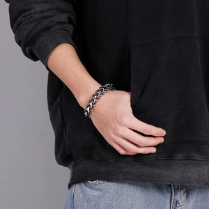 Close-up of men's chunky silver stainless steel chain bracelet on wrist street style