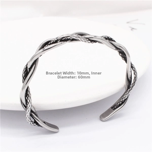 Detail of 10mm wide twisted rope titanium steel cuff bracelet with textured scale finish