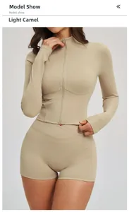Detail of light camel long sleeve zip jacket and high waist gym shorts with side pockets