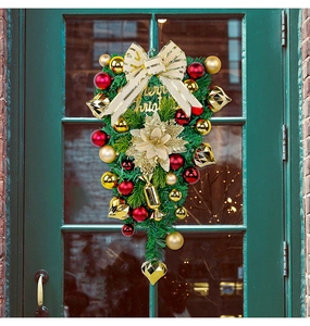 Close-up of a Christmas teardrop swag with red and gold baubles and a Merry Christmas sign