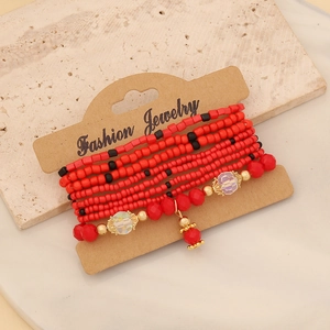 Bohemian multi-layer beaded bracelet set in vibrant red and gold on vintage card