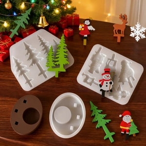 Macro detail of Christmas tree and reindeer silicone molds with festive resin ornaments