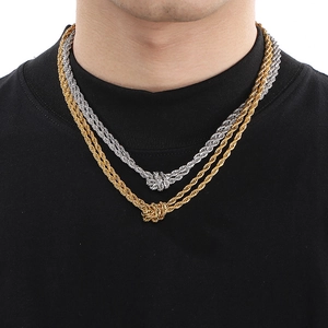 Detail of gold and silver double-layered rope chain necklaces on model neck