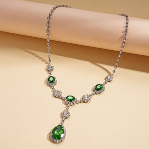 Elegant silver necklace with green teardrop pendant and crystal halo in vintage royal style