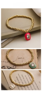 Detailed view of luxury gold bead bracelets with colorful enamel octagon pendants
