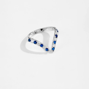Macro shot of S925 sterling silver V-shaped ring with blue and white gems and hallmark