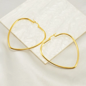 Chic 18K gold-plated irregular heart-shaped hoop earrings on white marble display
