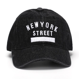 Detail of white NEW YORK STREET embroidery on high-quality black denim baseball cap