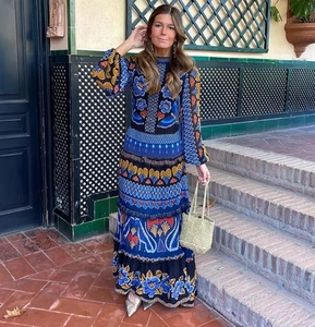 Outdoor shot of boho printed maxi dress with stand collar and long sleeves on a model
