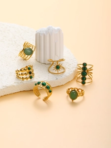 Detail of assorted 18k gold plated stainless steel rings with green malachite stones