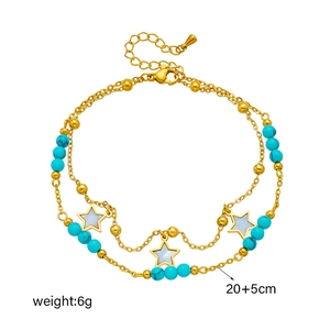 Double-layered gold chain anklet featuring blue beads and white star pendants on white background