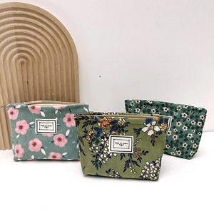 Three vintage floral corduroy cosmetic bags for travel with zipper closure and white label