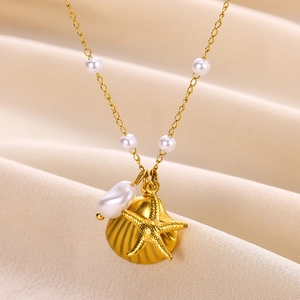 Gold stainless steel starfish and shell pearl necklace set on smooth silk fabric