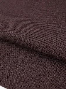 Close-up of fine-knit dark brown fabric showing detailed ribbed texture and fiber weave