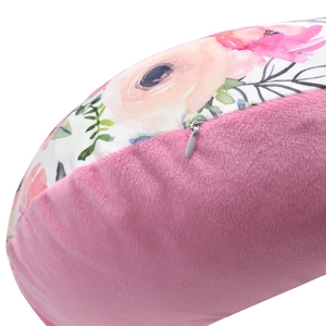 Detail of pink plush nursing pillow cover with floral pattern and hidden zipper