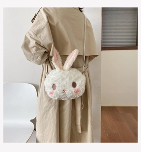 Cute white plush rabbit crossbody bag with elegant pearl chain strap shown on model