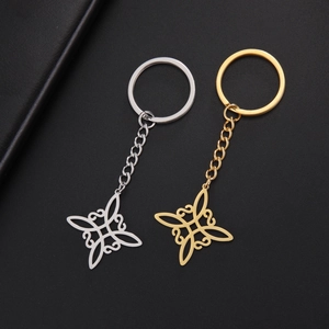 Stainless steel Celtic knot keychains in gold and silver finish on black texture