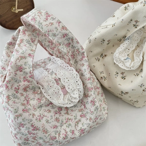 Detail of floral canvas tote bags with delicate white lace trim and heart buttons