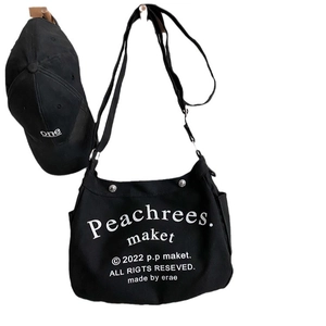 Versatile black canvas tote bag with adjustable shoulder strap and print lettering