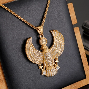 Detail of hip hop gold Horus falcon pendant with rhinestones on a leather stand