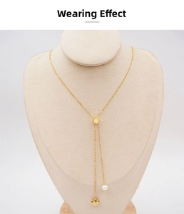 Detail of adjustable gold Y-necklace featuring a heart charm and elegant white faux pearl