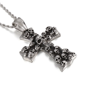 Silver stainless steel cross pendant with skull embossing on a metal twisted chain