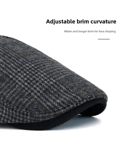 Detail of gray plaid wool beret showing foldable brim and thickened textured fabric