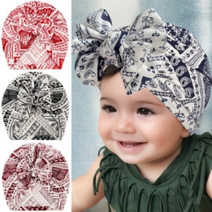 Detail of baby turban hat featuring classic paisley print in multiple color options