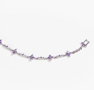 Detail of silver clover bracelet featuring purple zircon floral clusters and lobster clasp