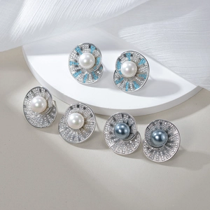 Luxurious S925 silver stud earrings with shells and blue pine zircons on marble display