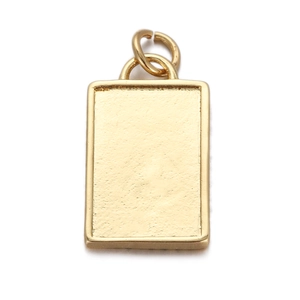 Detail of a textured golden rectangular metal pendant charm with double connection rings